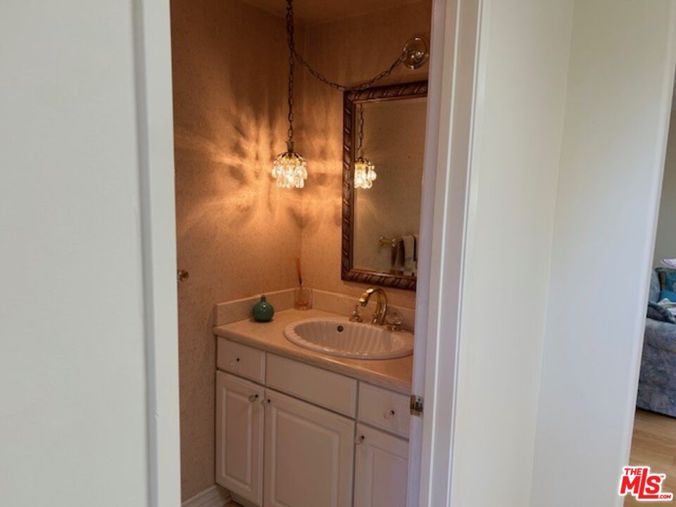 3908 Castlerock Road Malibu, CA 90265 - Photo 7 of 17 a bathroom with a sink and mirror