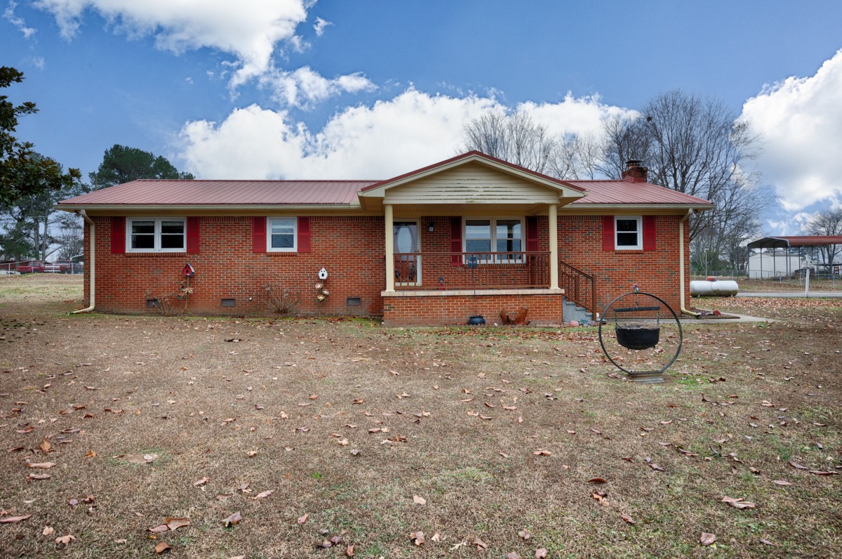 14052 Elk River Mills Road Athens, AL 35614 - Photo 1 of 43 a front view of a house with garden