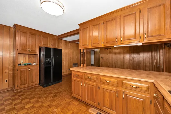 a kitchen with stainless steel appliances granite countertop a refrigerator and cabinets