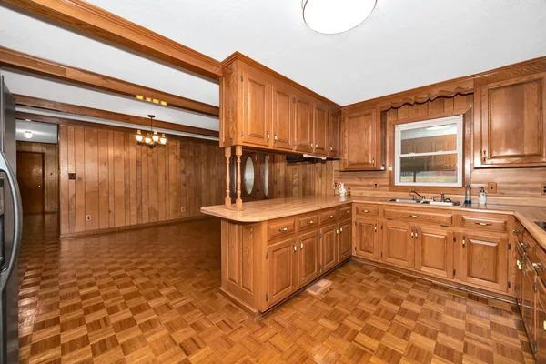 a kitchen with stainless steel appliances granite countertop a sink stove and cabinets