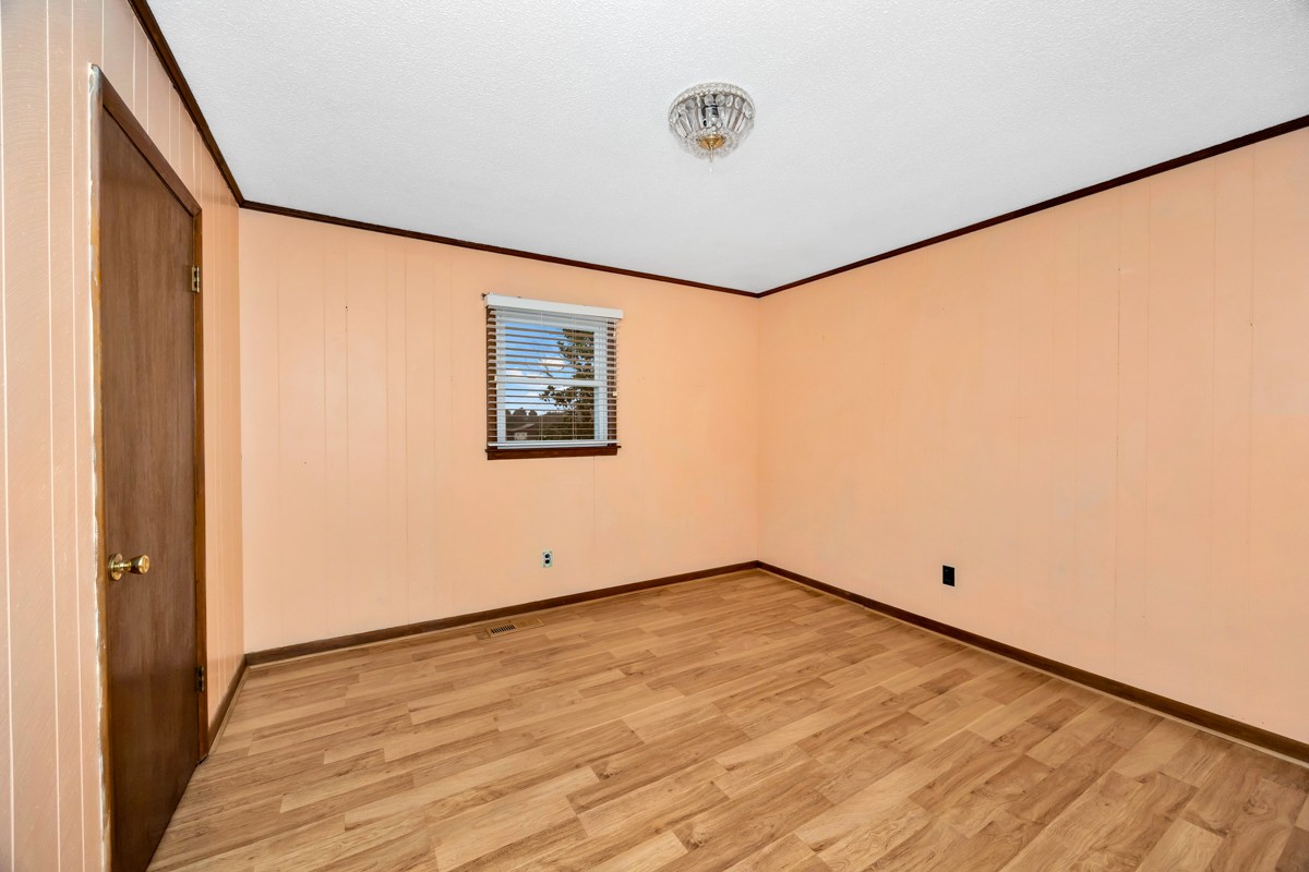 14052 Elk River Mills Road Athens, AL 35614 - Photo 13 of 43 a view of an empty room with wooden floor and a window