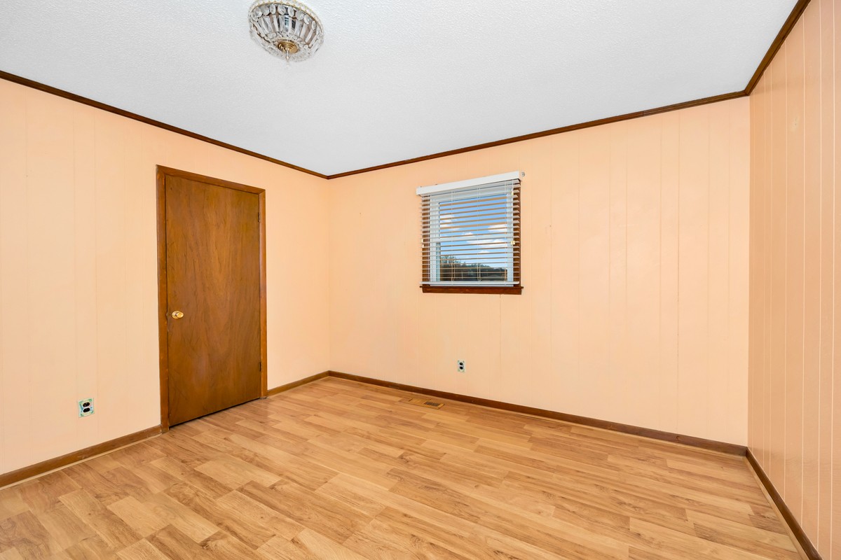 14052 Elk River Mills Road Athens, AL 35614 - Photo 14 of 43 an empty room with wooden floor and windows
