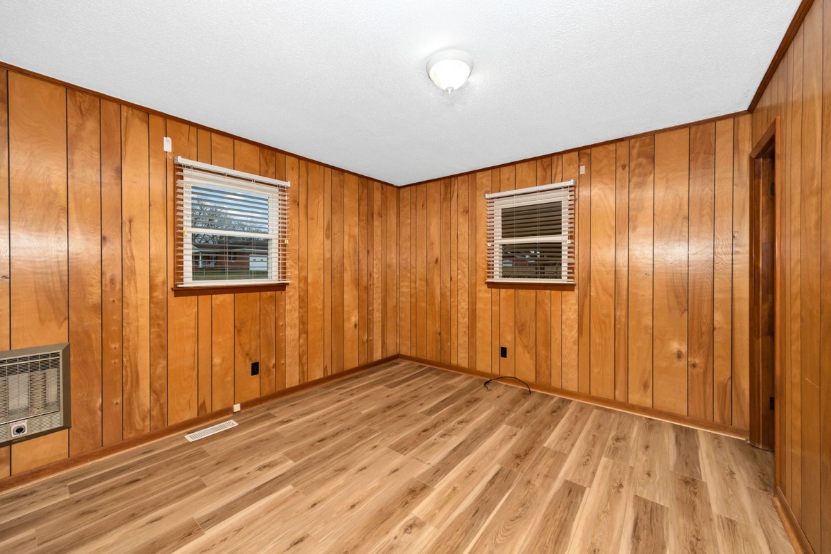 14052 Elk River Mills Road Athens, AL 35614 - Photo 17 of 43 an empty room with wooden floor and windows
