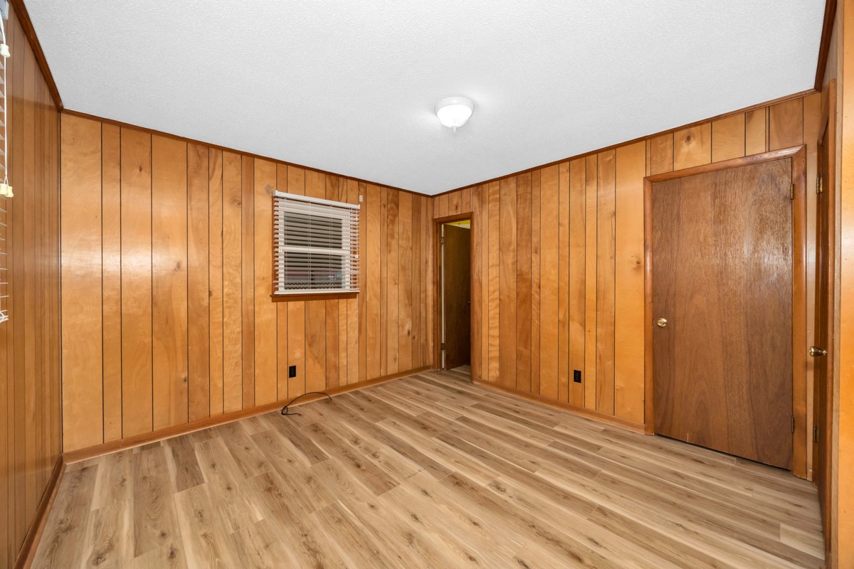 14052 Elk River Mills Road Athens, AL 35614 - Photo 18 of 43 a view of an empty room with wooden floor and a window