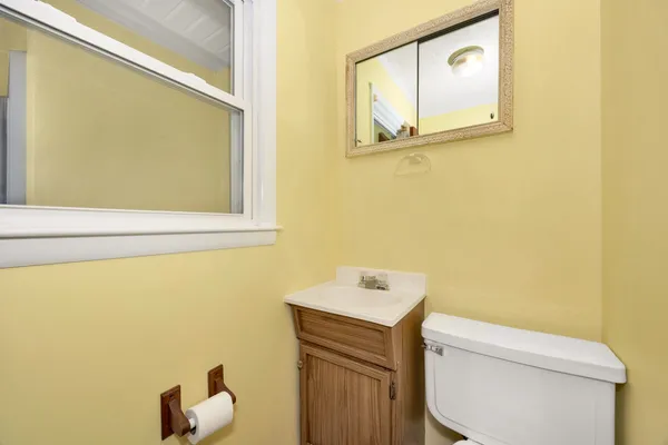 a bathroom with a toilet sink and mirror