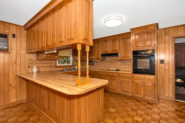 a kitchen with stainless steel appliances granite countertop a sink a stove and a refrigerator