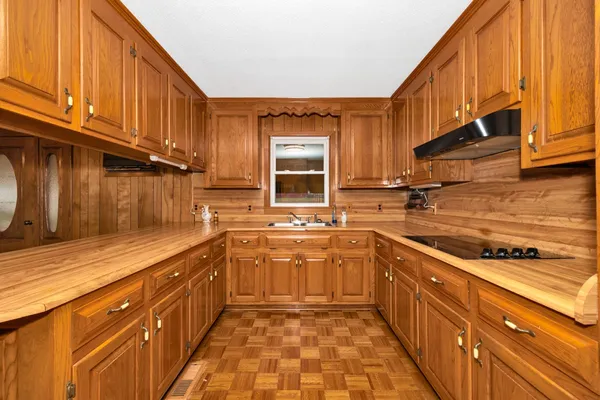 a kitchen with stainless steel appliances a sink stove and cabinets
