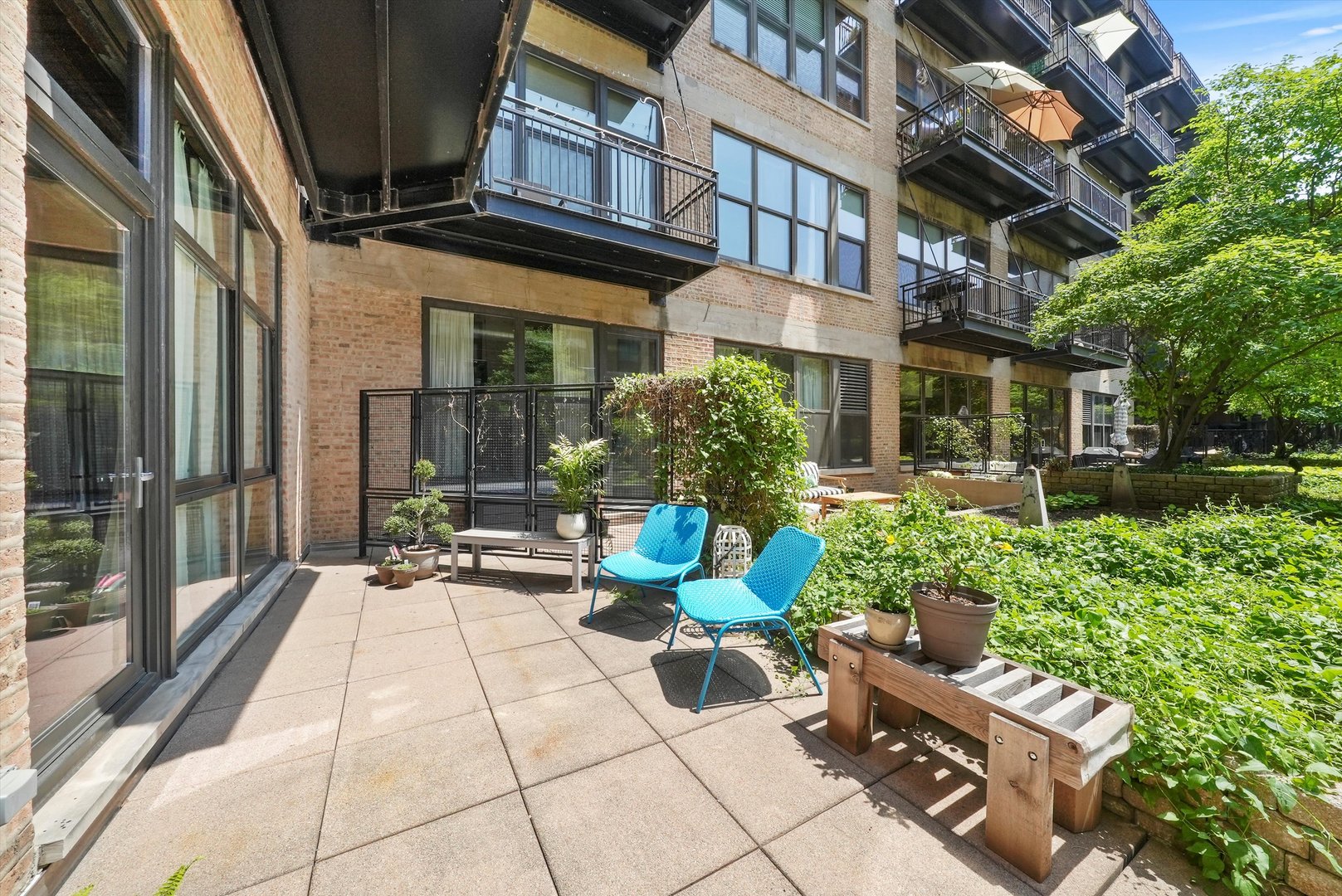 1040 West Adams Street, Unit 213 Chicago, IL 60607 - Photo 15 of 30 a view of a patio with table and chairs and potted plants
