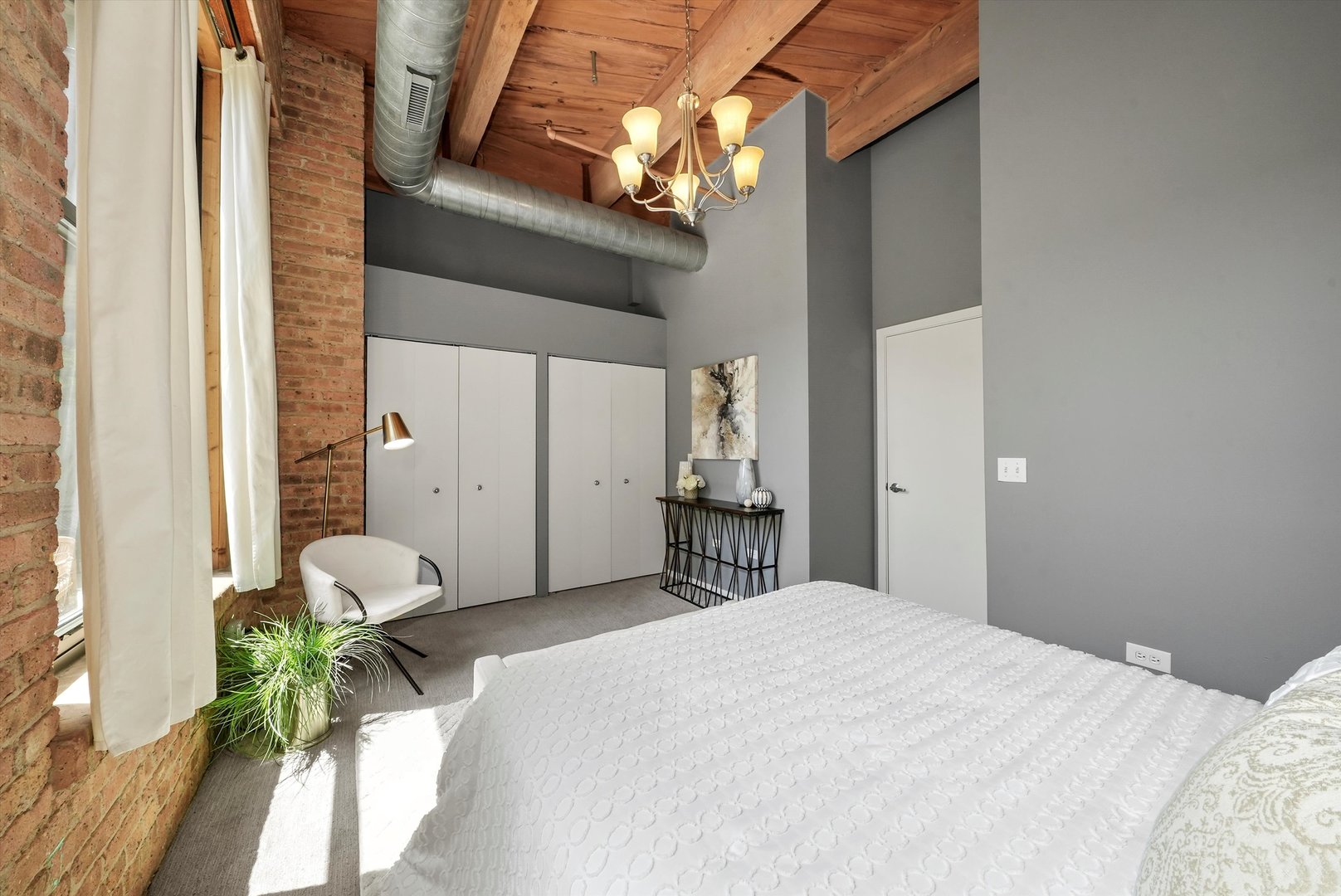 1040 West Adams Street, Unit 213 Chicago, IL 60607 - Photo 18 of 30 a bedroom with a bed dresser and a window