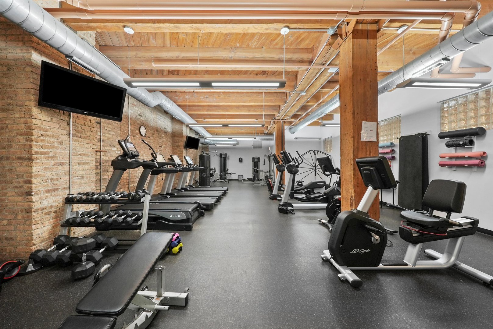 1040 West Adams Street, Unit 213 Chicago, IL 60607 - Photo 21 of 30 a view of a room with gym equipment