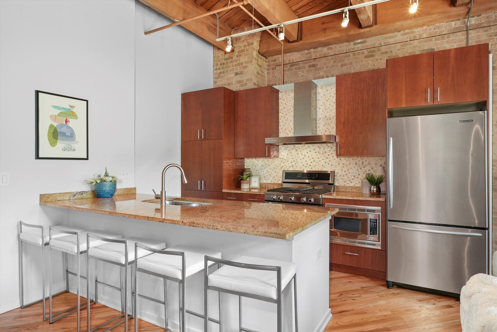 1040 West Adams Street, Unit 213 Chicago, IL 60607 - Photo 3 of 30 a kitchen with stainless steel appliances granite countertop a stove a refrigerator and a sink