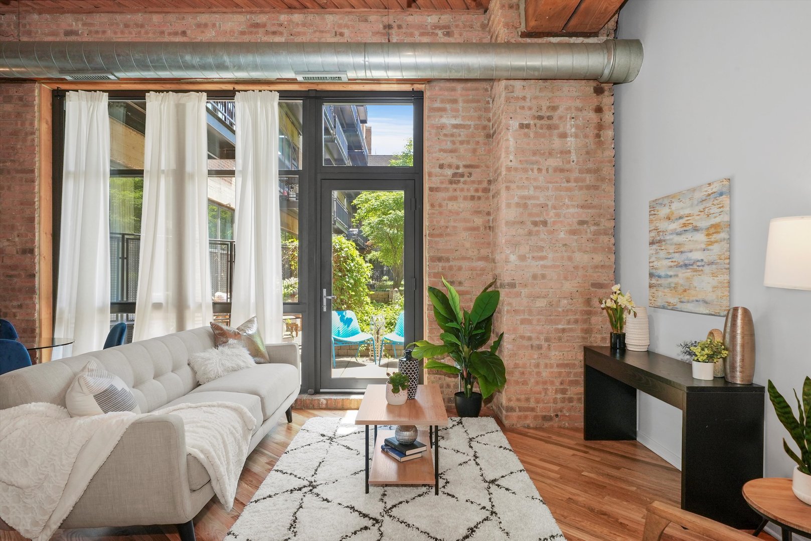 1040 West Adams Street, Unit 213 Chicago, IL 60607 - Photo 6 of 30 a living room with furniture and large windows