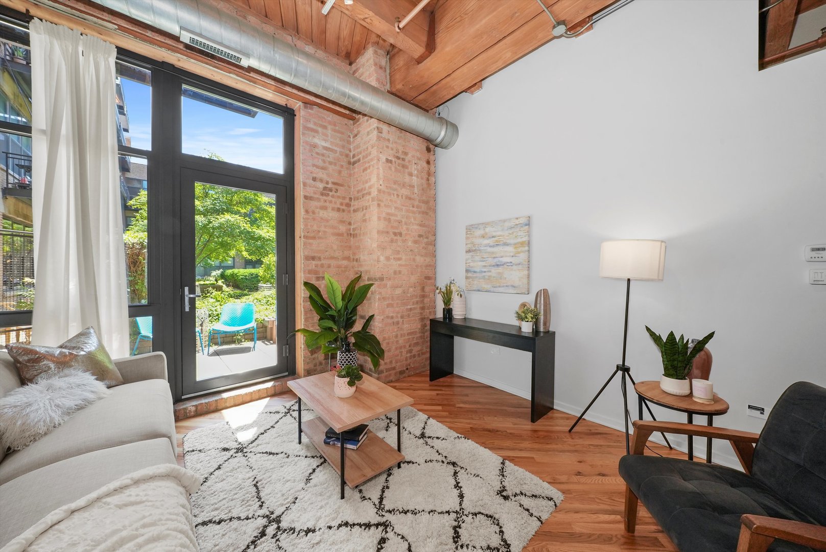 1040 West Adams Street, Unit 213 Chicago, IL 60607 - Photo 7 of 30 a living room with furniture and a potted plant