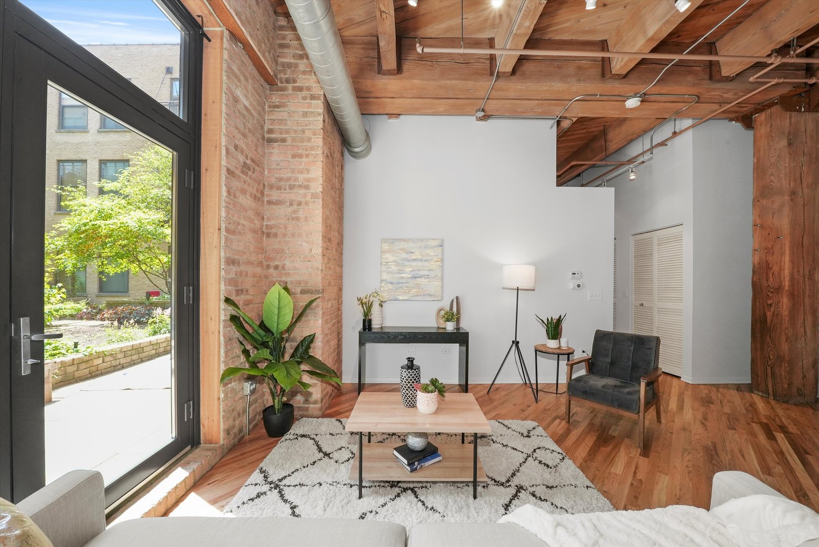 1040 West Adams Street, Unit 213 Chicago, IL 60607 - Photo 8 of 30 a living room with furniture and wooden floor