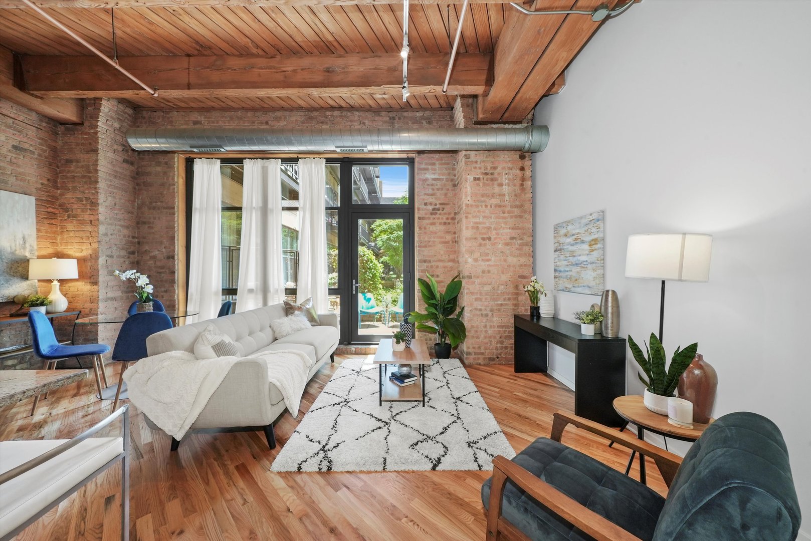 1040 West Adams Street, Unit 213 Chicago, IL 60607 - Photo 9 of 30 a living room with furniture a table and a potted plant