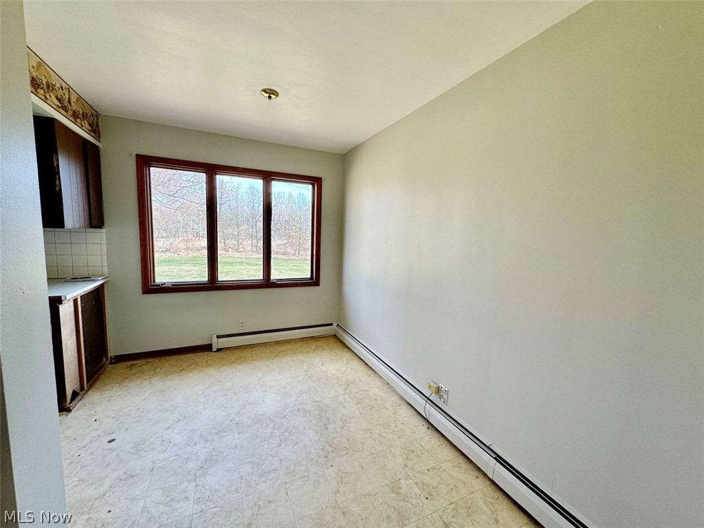 1445 Killian Road Akron, OH 44312 - Photo 8 of 21 Dining area featuring a baseboard radiator and light tile flooring