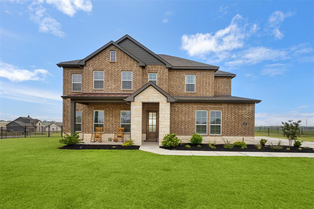 107 Yampa Court Rhome, TX 76078 - Photo 1 of 30 Two-story brick exterior with stone accents and a covered front porch