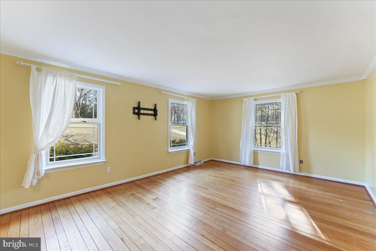 97 Quail Run Kennett Square, PA 19348 - Photo 11 of 34 a view of an empty room with wooden floor and a window