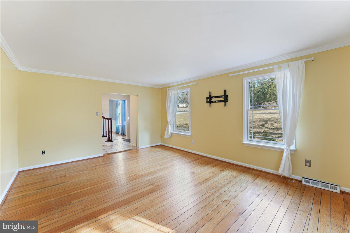 97 Quail Run Kennett Square, PA 19348 - Photo 12 of 34 a view of an empty room with a window and wooden floor