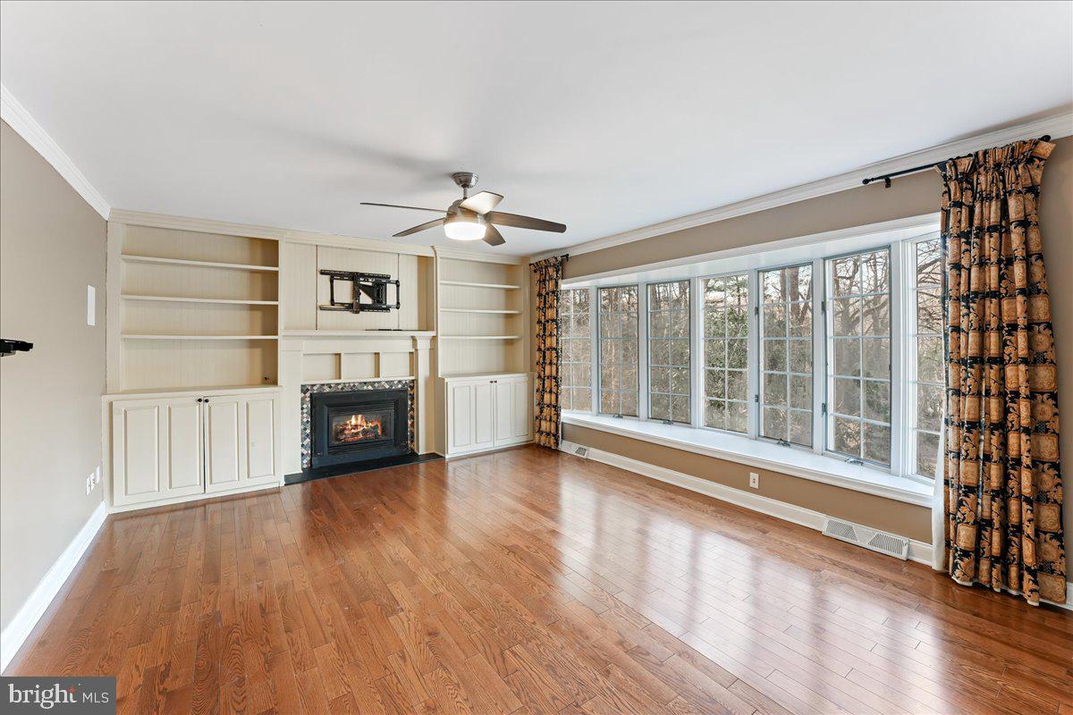 97 Quail Run Kennett Square, PA 19348 - Photo 14 of 34 a view of a livingroom with wooden floor a fireplace and window