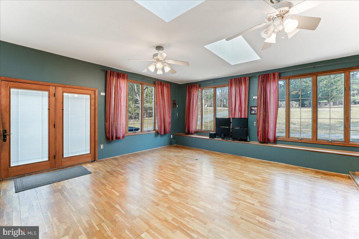 97 Quail Run Kennett Square, PA 19348 - Photo 18 of 34 a view of empty room with wooden floor and fan