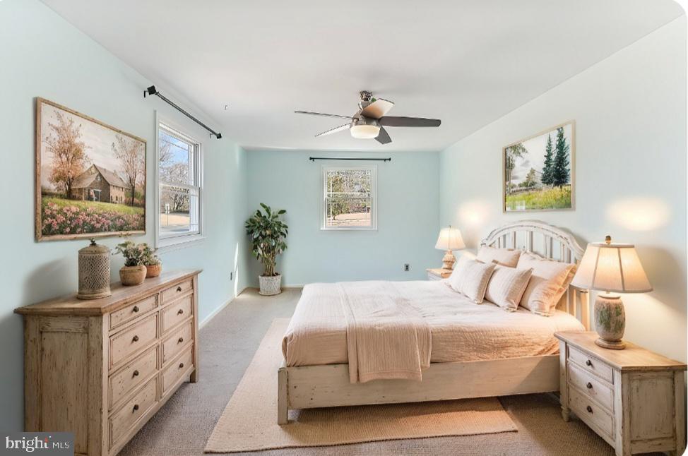 97 Quail Run Kennett Square, PA 19348 - Photo 21 of 34 a bedroom with a large bed and a chandelier