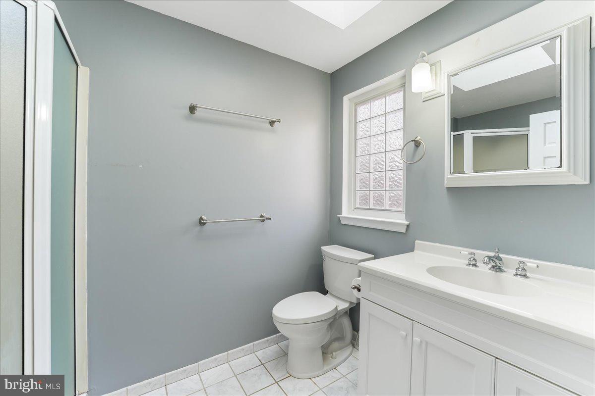 97 Quail Run Kennett Square, PA 19348 - Photo 24 of 34 a bathroom with a toilet a sink a mirror and a window