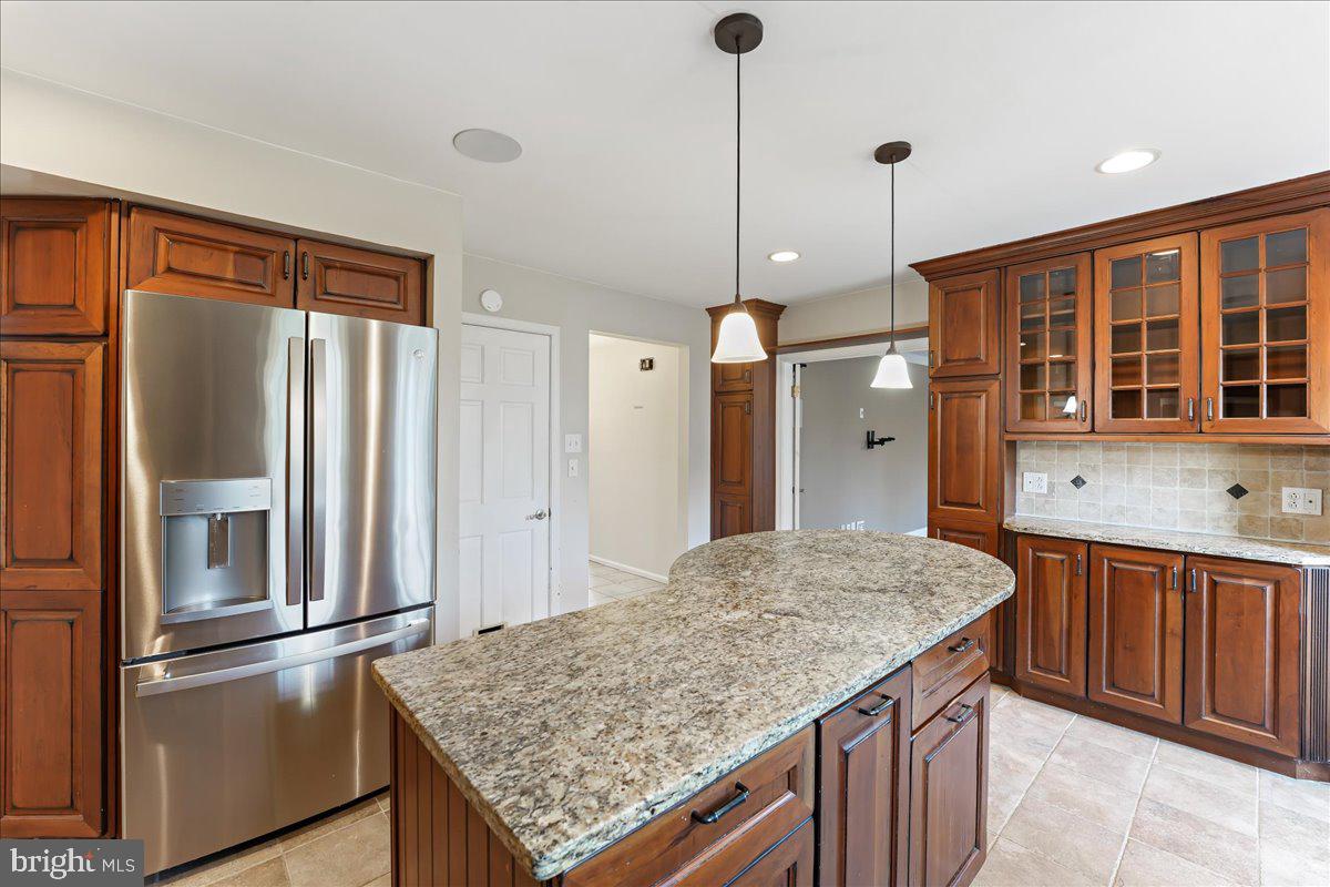 97 Quail Run Kennett Square, PA 19348 - Photo 3 of 34 a kitchen with stainless steel appliances granite countertop a refrigerator a sink and wooden cabinets