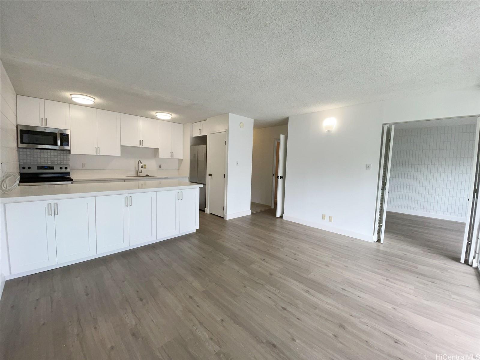 827 Kinau Street, Unit 601D Honolulu, HI 96813 - Photo 1 of 1 a view of a kitchen with a sink and a refrigerator