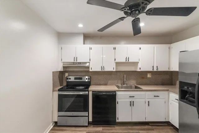 a kitchen with cabinets and stainless steel appliances