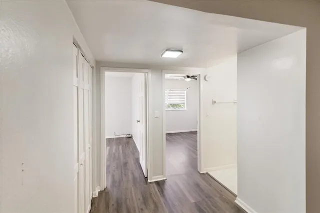 a view of hallway with wooden floor