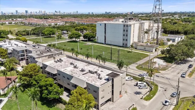 an aerial view of a house with a garden and lake view