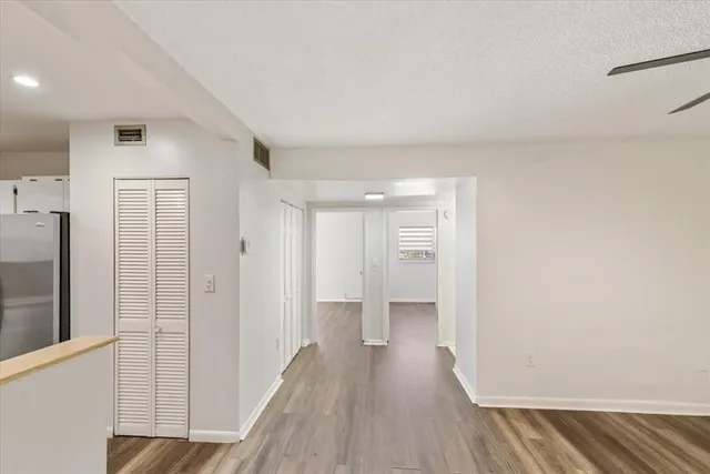 a view of a room with wooden floor and a window