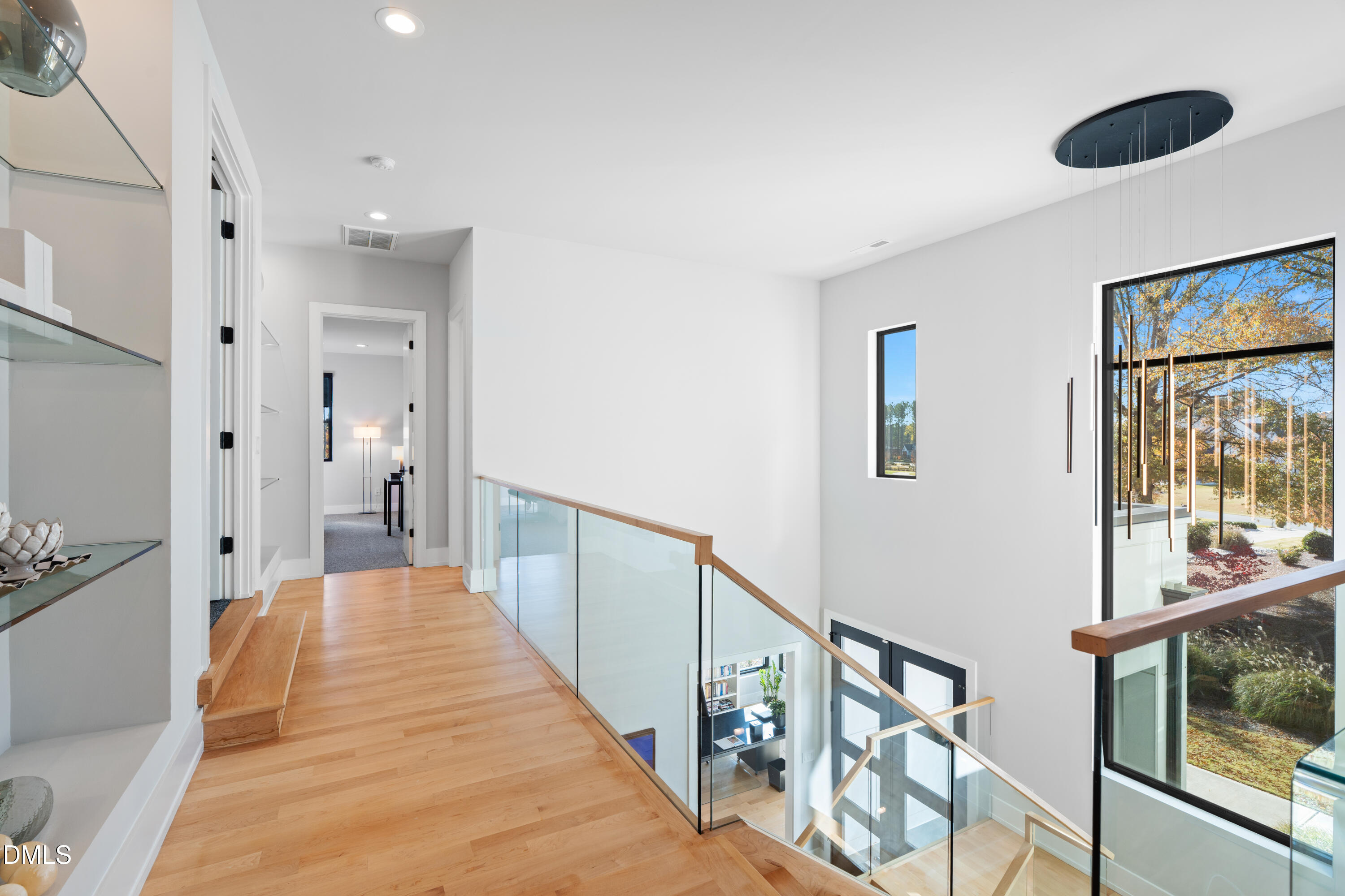 132 Edward Booth Lane Durham, NC 27713 - Photo 37 of 75 a view of a hallway with wooden floor and windows