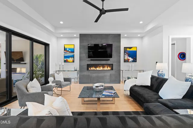 a living room with fireplace furniture and a flat screen tv
