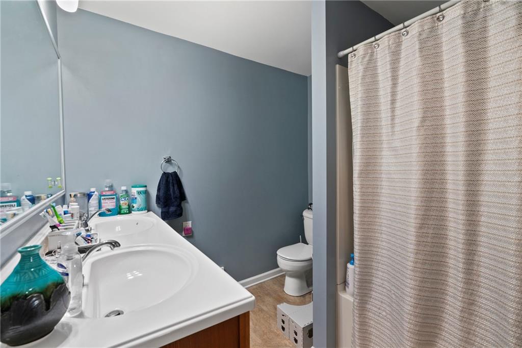 1807 Pine Hollow Road McKees Rocks, PA 15136 - Photo 18 of 47 a bathroom with a sink a toilet and shower curtain