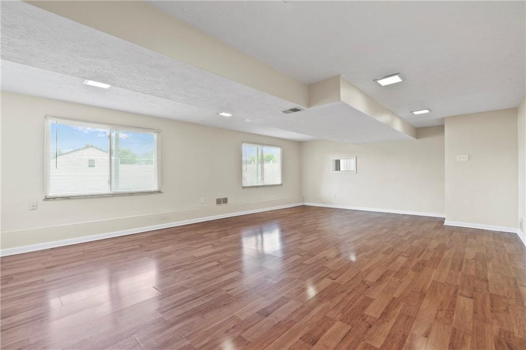 1807 Pine Hollow Road McKees Rocks, PA 15136 - Photo 33 of 47 an empty room with wooden floor and windows