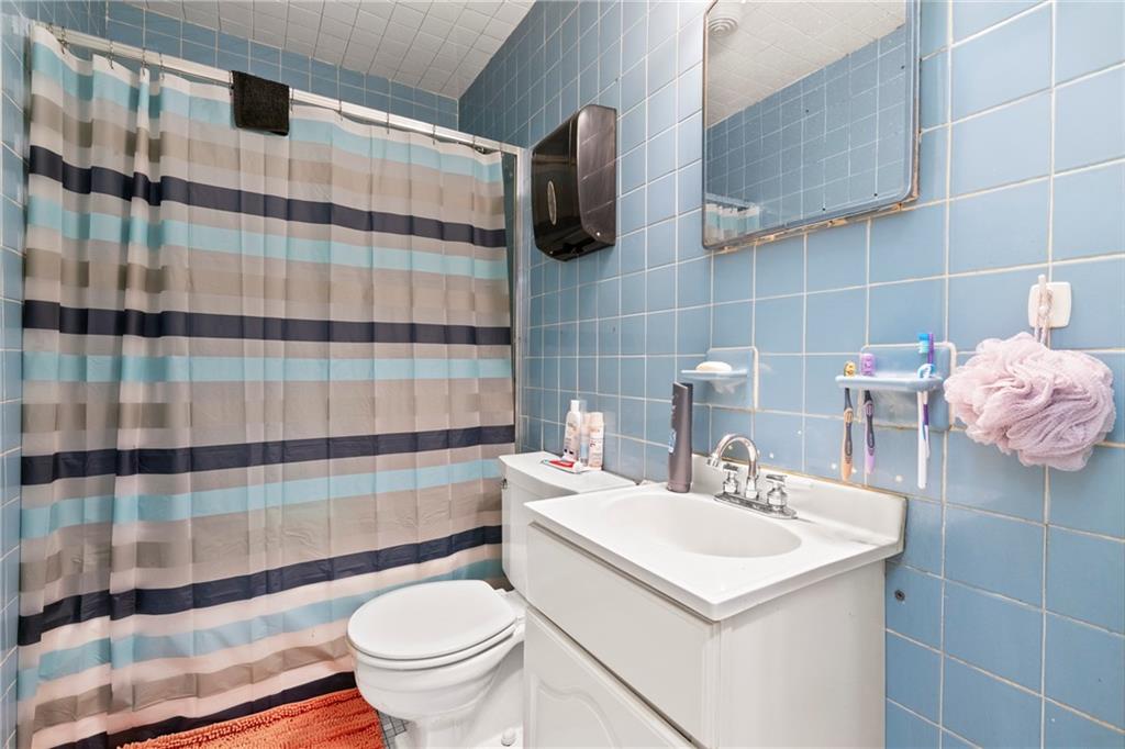 1807 Pine Hollow Road McKees Rocks, PA 15136 - Photo 6 of 47 a bathroom with a sink toilet and shower