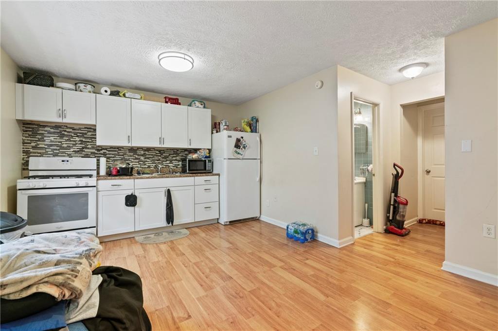 1807 Pine Hollow Road McKees Rocks, PA 15136 - Photo 9 of 47 a kitchen with a refrigerator and a stove top oven