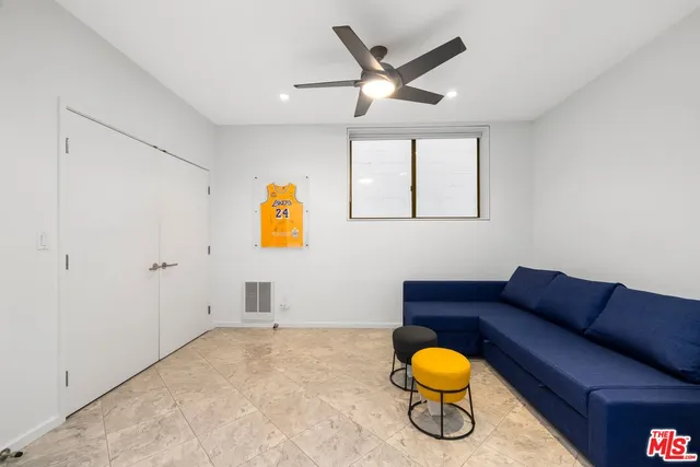 a living room with furniture a air conditioner vent and a window