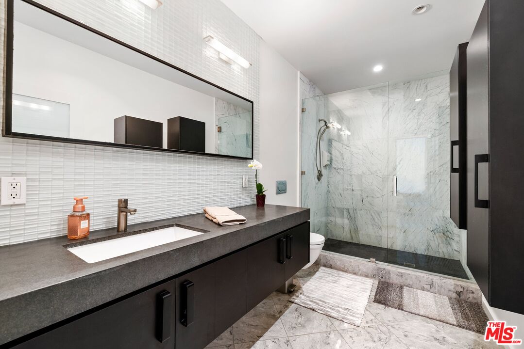 3007 Ocean Front Walk Venice, CA 90291 - Photo 20 of 33 a bathroom with a sink and a mirror