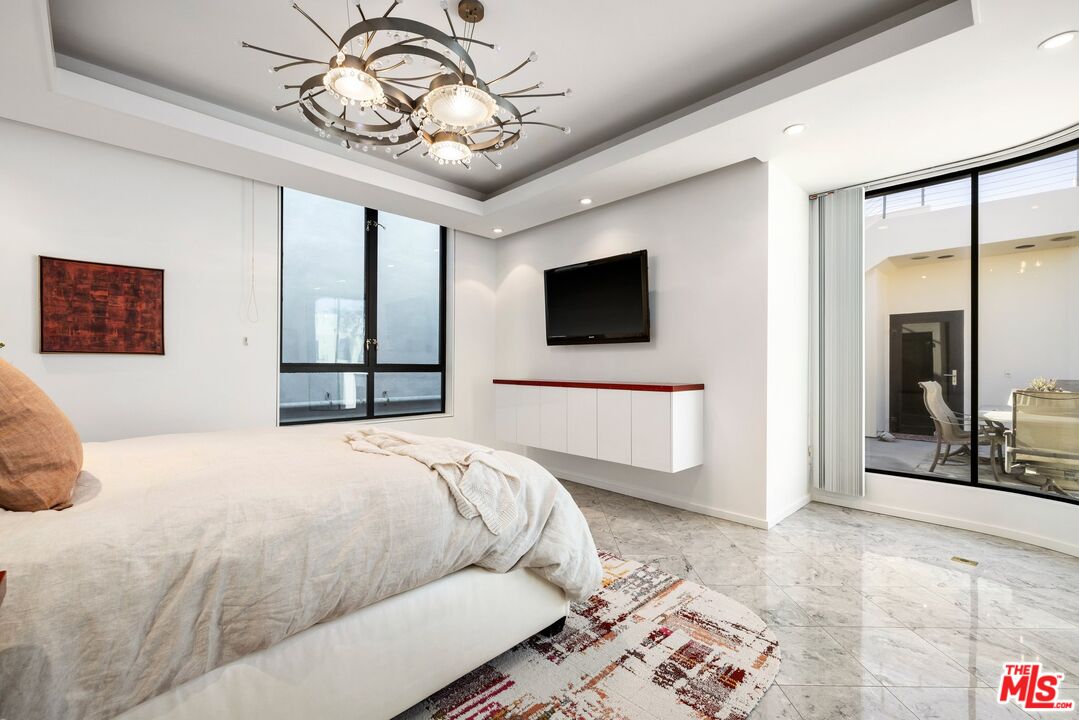 3007 Ocean Front Walk Venice, CA 90291 - Photo 22 of 33 a bedroom with a bed and a flat screen tv