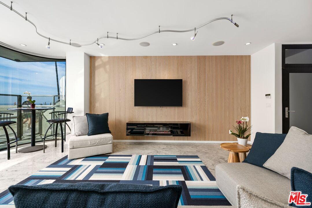 3007 Ocean Front Walk Venice, CA 90291 - Photo 9 of 33 a living room with furniture and a flat screen tv