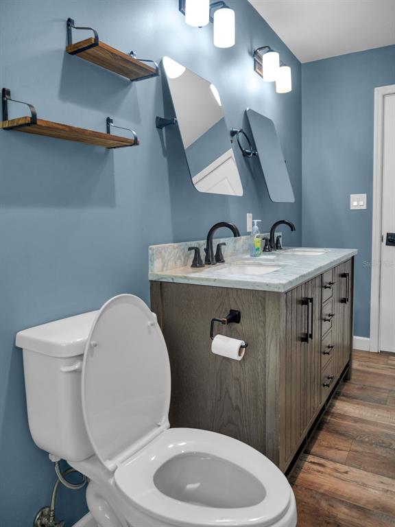 628 Bethel Street Keystone Heights, FL 32656 - Photo 27 of 49 a bathroom with a toilet a sink and mirror