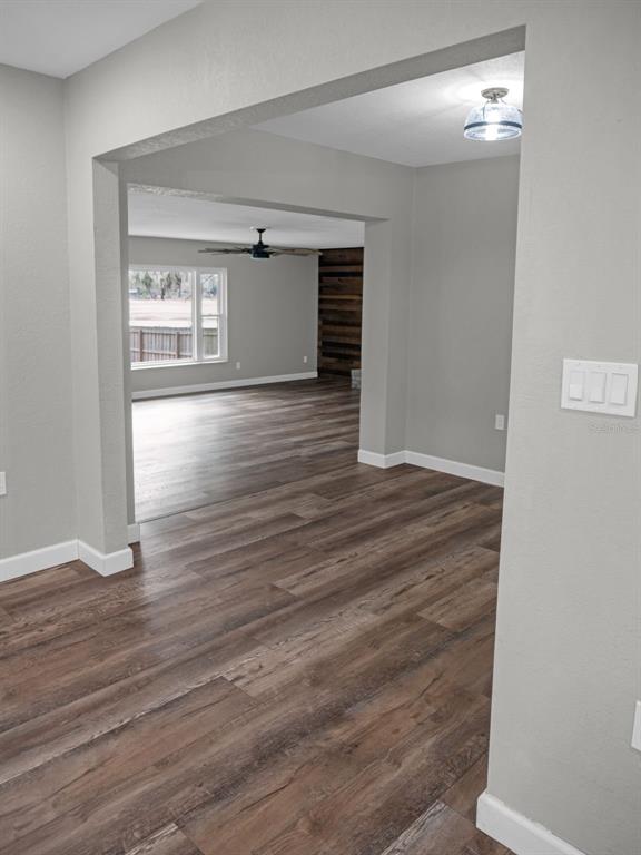 628 Bethel Street Keystone Heights, FL 32656 - Photo 28 of 49 a view of an empty room with wooden floor and a window