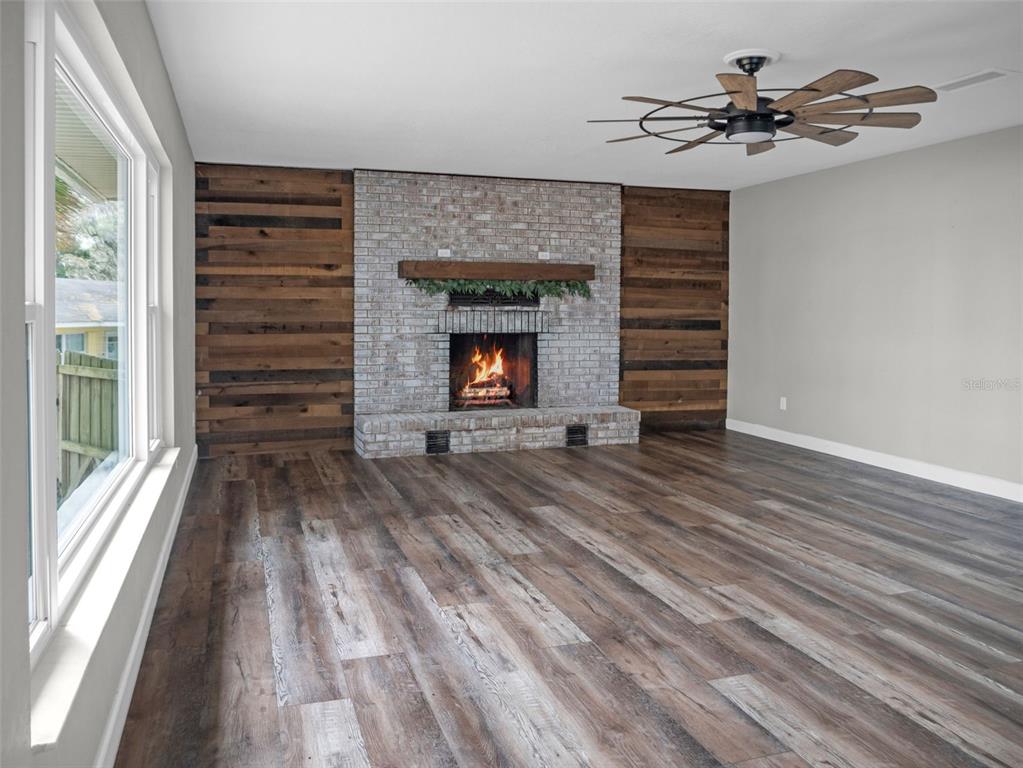 628 Bethel Street Keystone Heights, FL 32656 - Photo 29 of 49 a view of a hallway with wooden floor and a chandelier