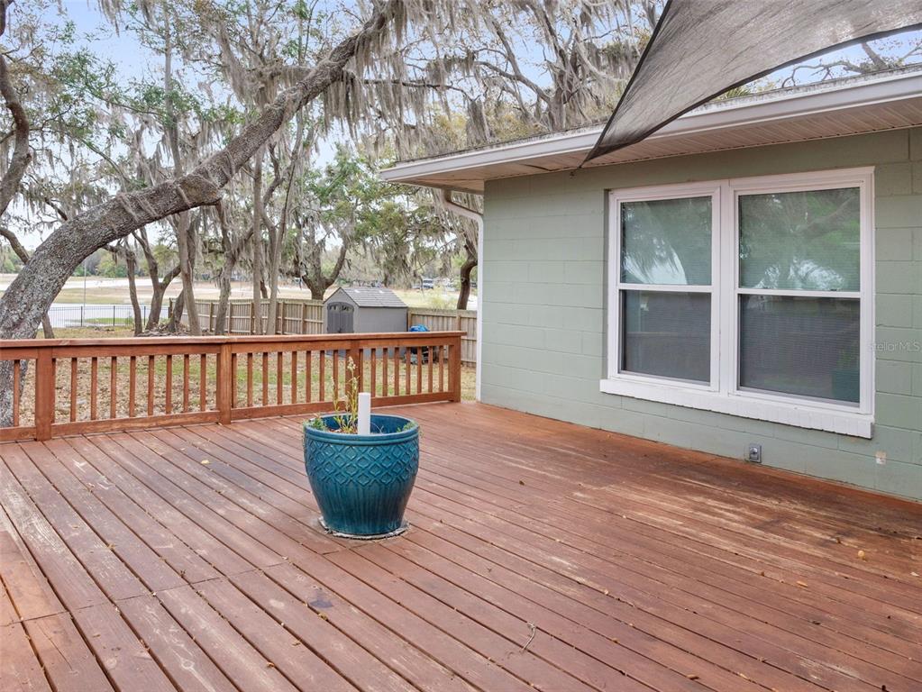 628 Bethel Street Keystone Heights, FL 32656 - Photo 33 of 49 a view of a wooden deck with a bench