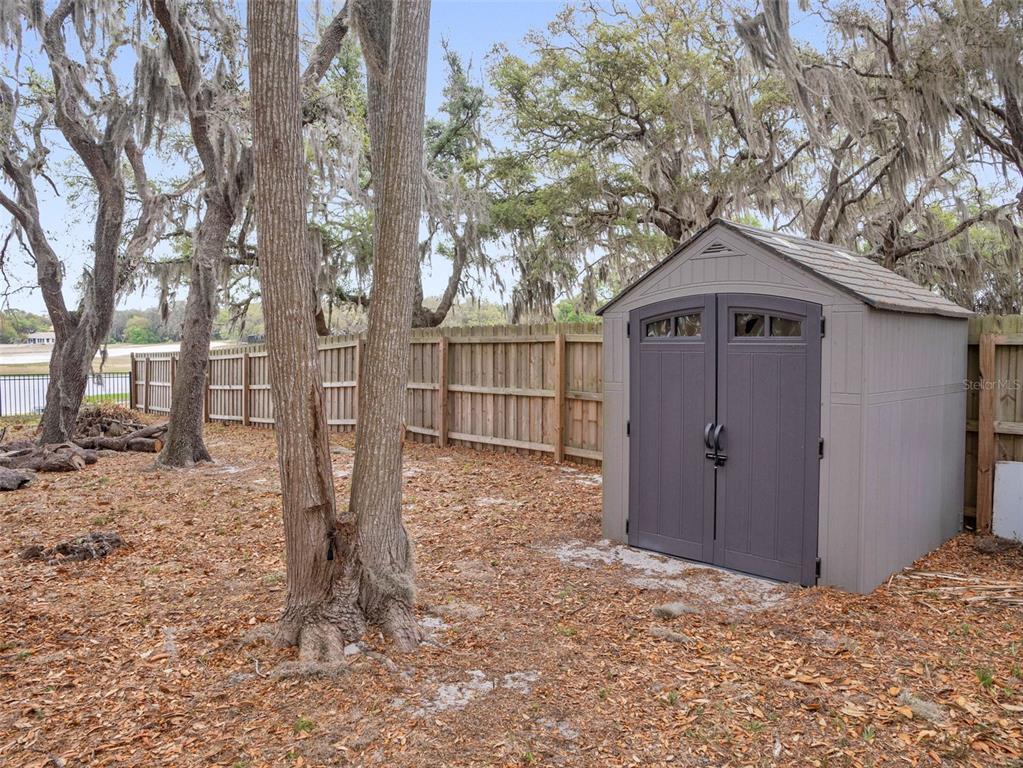 628 Bethel Street Keystone Heights, FL 32656 - Photo 40 of 49 a view of a wooden house with a large tree and wooden fence