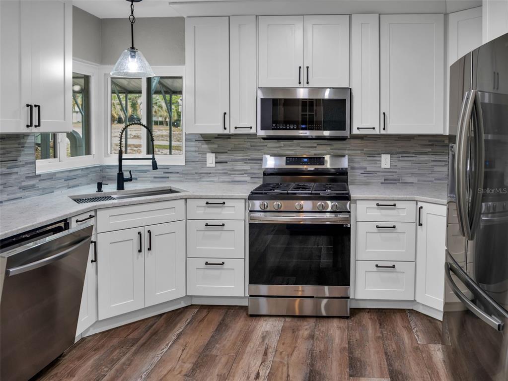 628 Bethel Street Keystone Heights, FL 32656 - Photo 7 of 49 a kitchen with stainless steel appliances a stove a sink and a microwave