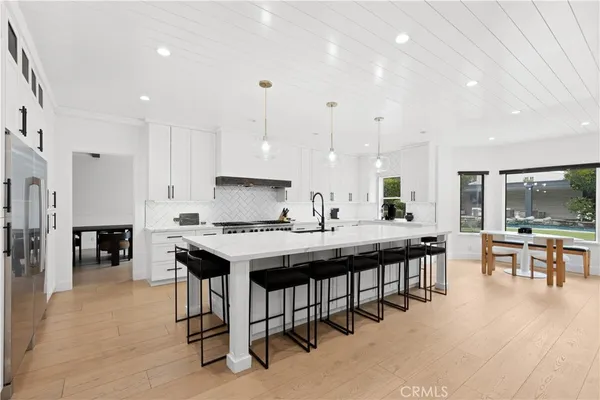 a large kitchen with a table and chairs